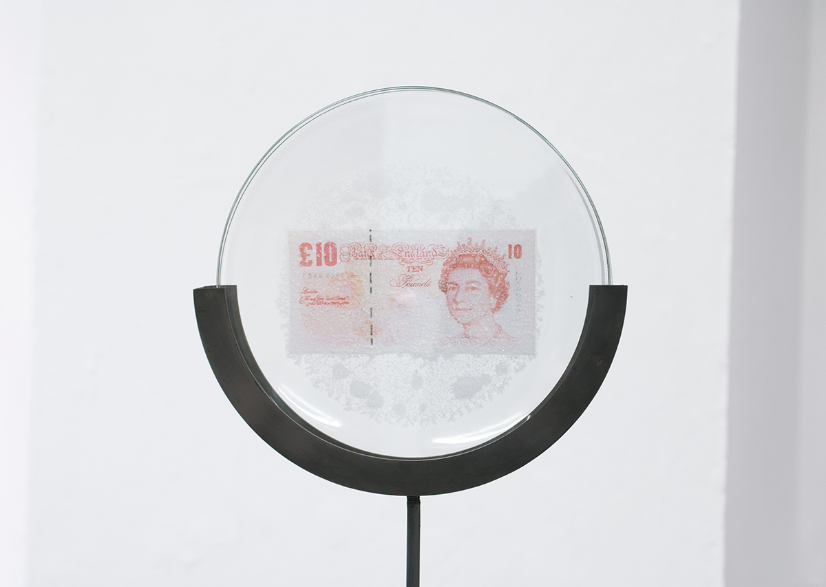 David Blackmore: Detail of £105,048.65: £10 Sterling banknote fused by bleach on to an IKEA plate on mild steel armature