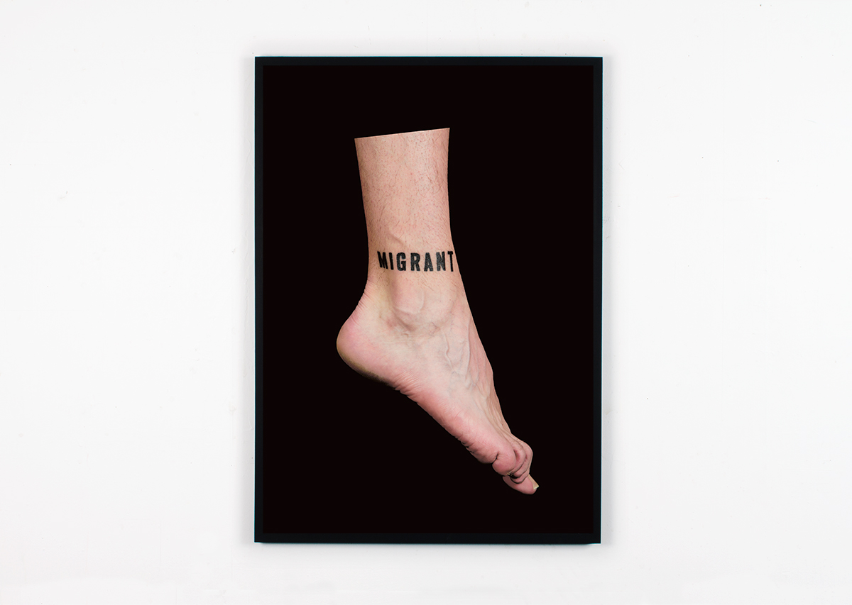 David Blackmore: Migrant (2017) Photographic document of the act of having the word MIGRANT tattooed on the artists ankle